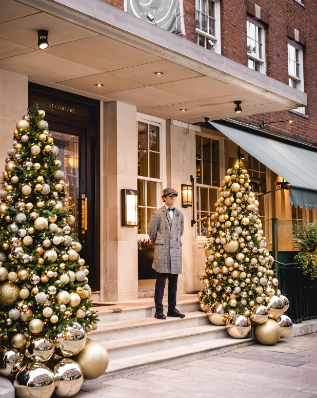 The doorman waiting on the steps of 34 Mayfair
