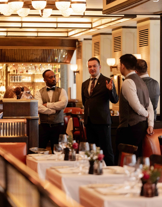 The 34 Mayfair team gathered in the dining room before service, chandeliers lit above