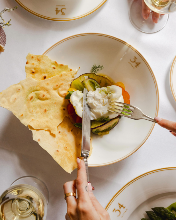 Weekend brunch from above: burrata, summer vegetables and flatbread on 34 china