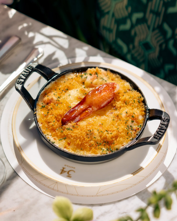 Lobster gratin in a cast-iron dish on the terrace